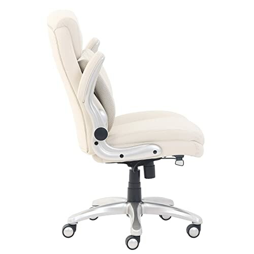 Side view of a beige office chair with armrests and wheels